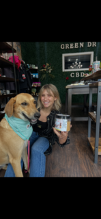 Madison smiling with her dog Patata in Green DR CBD FEEL GOOD store Madison is using Green DR CBD dog treats to help Patata manage extreme anxiety.